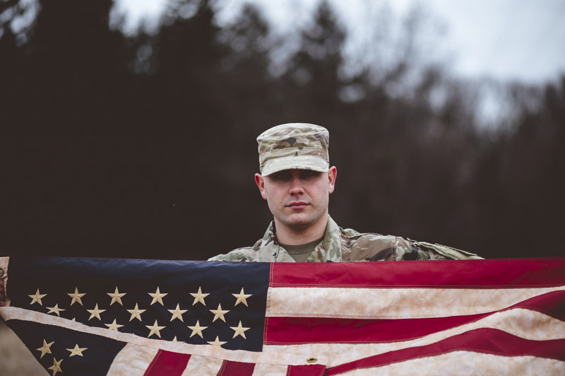 shallow-focus-shot-american-soldier-holding-american-flag-1